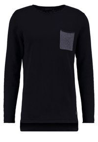 Svart långärmad skjorta i mjukt material, med en mörkgrå bröstficka och en avslappnad passform. Slät textur och rundad halsringning.