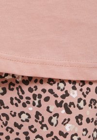 Pink cotton fabric with a smooth texture at the top, paired with a bottom featuring a leopard print in black, cream, and light pink.