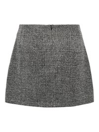 Tvid suknja crno-bijele boje s prilagođenim krojem, pojasom i skrivenim stražnjim patentnim zatvaračem. Tkanina s teksturom i suptilnim uzorkom.