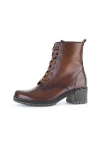 Bottines en cuir marron avec un bout arrondi, un laçage, des accents texturés, une languette à l'arrière et un talon en caoutchouc épais pour une bonne adhérence.