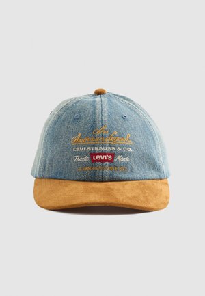 Denim baseball cap with brown suede brim, featuring Levi's branding and text embroidered in yellow, white, and red on front panel.