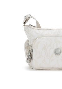 Borsa a spalla beige chiaro con motivo floreale, chiusura con zip e accessori in argento. Caratterizzata da un portachiavi e dettagli con logo.