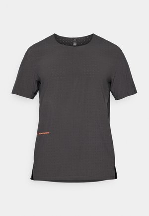 Short-sleeve, black athletic t-shirt with perforated pattern, side slits, and orange logo detail at the hem. Smooth, lightweight fabric.
