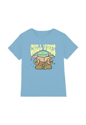 Light blue t-shirt with a meditating green character wearing a brown robe and "CHILL VIBES" text in yellow above it.