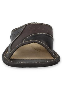 Black leather slide sandal with an open toe, contrasting brown stitching, and perforated details on the strap for breathability.