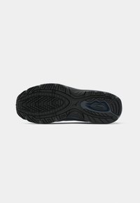 Black rubber shoe sole with a textured tread pattern, featuring grooves and ridges for grip. Smooth finish with no visible accents.