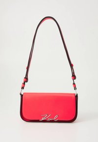 Crossbody bag in bright pink and black leather with a sleek rectangular shape and silver logo accent on the front. Adjustable strap included.