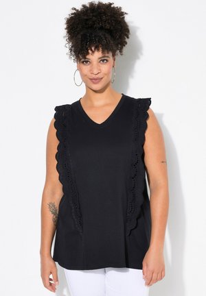 Black sleeveless top featuring a scalloped lace trim along the shoulders and down the sides, with a V-neckline and soft fabric texture.