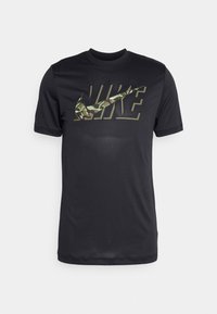 Camiseta negra de manga corta hecha de una tela suave, con un gran logotipo de Nike en gris y camuflaje en la parte frontal.