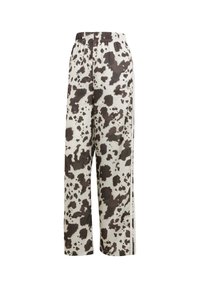 Beiga vida byxor med ett brunt nötkreaturstryck, med ett elastiskt midjeband och sidostreck. Slät tygtextur.