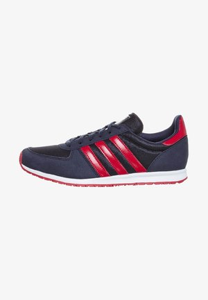 Navy blue athletic shoes with red stripes, mesh panels, and cushioned soles. Features a rounded toe and a white rubber outsole.
