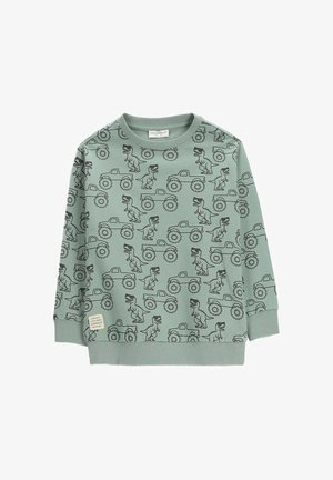 Jasnozielona dziecięca bluza z czarnym wzorem dinozaura i monster trucka, ściągaczami na rękawach i u dołu oraz małą metką materiałową.
