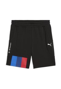 Shorts de sport noirs en tissu lisse avec une ceinture élastique, dotés de poches latérales inclinées et d'un design bicolore bleu et rouge sur la jambe gauche.