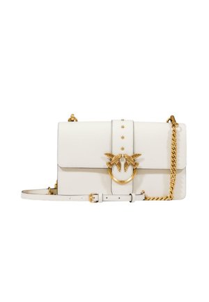 Witte leren handtas met een gouden ronde hardware-detail met twee vogelaccenten, een kettingband en studded versieringen.