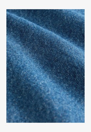 Denim fabric in a deep blue hue, showcasing a smooth texture with visible weaving patterns and subtle color variations.