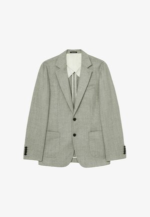 Hall hallitus jope, mis on varustatud lõhiklapiga, ühe nupu esiga, kahe klapiga taskuga ja kolme musta nupuga igas varruka otsas. Vooderdatud sisemus on nähtav.