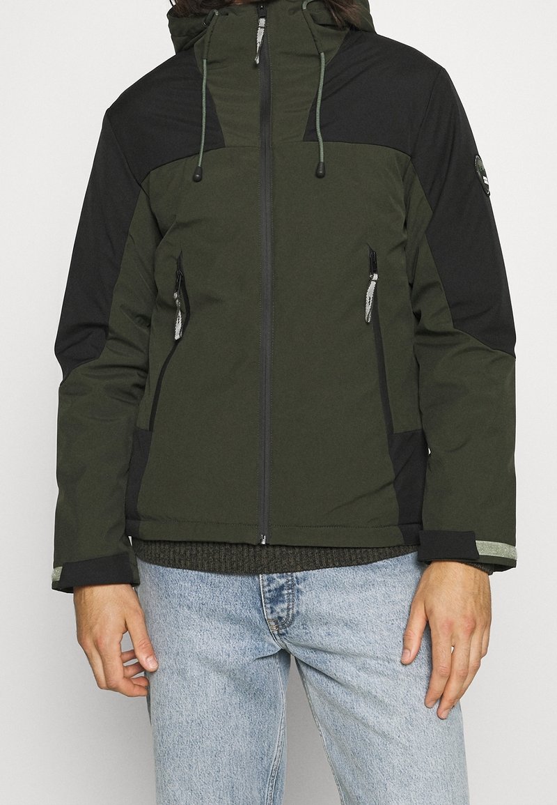 Grön och svart huva jacka med framdragkedja, två sidofickor och justerbara snoddar. Har kontrasterande färgpaneler och texturerad tyg.