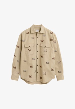Beige button-up shirt with collar and chest pockets, featuring a pattern of small brown and white dogs in various poses.