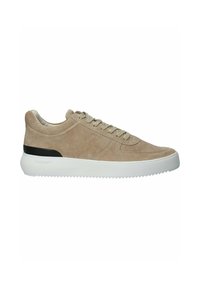 Beige suede sneakers with a white rubber sole, featuring round laces, a textured toe cap, and a black heel accent.