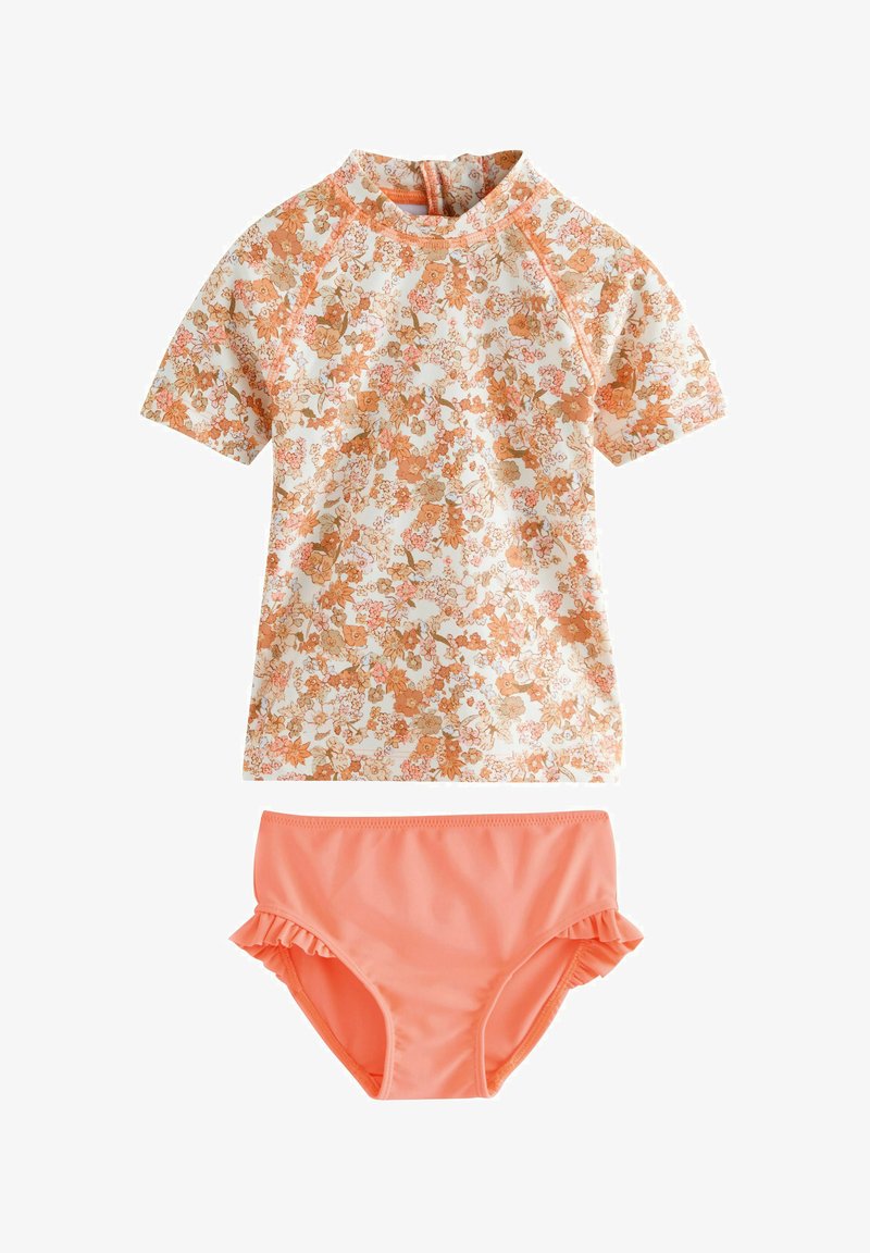 Ensemble de maillot de bain deux pièces comprenant un haut à manches courtes à motif floral en pêche et blanc, assorti à un bas rufflé uni en corail.