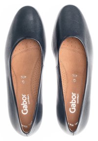 Ballerines en cuir noir avec bouts ronds, présentant une surface lisse et une semelle intérieure légèrement rembourrée avec des trous de ventilation. Marque Gabor visible.