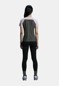 Round-neck athletic top with short pink sleeves, dark gray body; paired with black leggings and gray athletic shoes. Smooth texture.