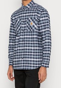 Blauwe en witte geruite overhemd met lange mouwen van katoen, met twee borstzakken, een button-down kraag en een logo patch aan de linkerkant.