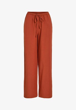 Rūdžių spalvos, plačios kelnės su elastingu juosmeniu ir priekyje rišama virvele, pagamintos iš minkštos medžiagos.