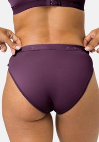 Purple stretch fabric panty with a smooth texture, featuring a comfortable waistband and minimal stitching details for a seamless look.