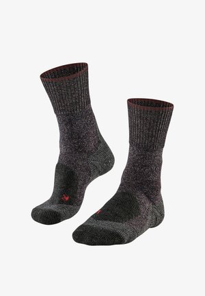 Calze grigie e testurizzate con polsino a coste, tallone e punta imbottiti e un piccolo logo rosso sul lato, progettate per il comfort e la durabilità.