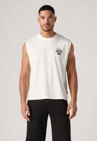 Λευκή αμάνικη βαμβακερή μπλούζα T-shirt με πολύχρωμο σχέδιο κλασμάτων και ήλιου κεντημένο μπροστά και μικρό μαύρο λογότυπο της Levi's.