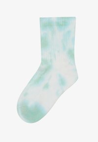 Hvite bomullssokker med lysegrønne tie-dye mønstre, ribbestruktur, midt på leggen lengde, glatt overflate og avrundet tå.