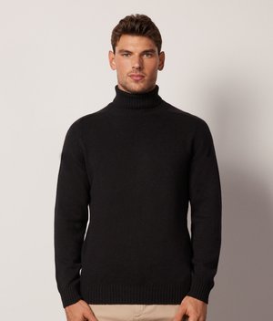 Schwarzer Rollkragenpullover aus Strickstoff, mit einer körpernahen Passform und geripptem Saum sowie Bündchen. Minimalistischer Stil ohne sichtbare Muster.