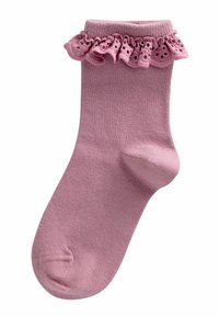 Calzino di cotone rosa chiaro con bordo di pizzo arricciato caratterizzato da un motivo ritagliato, texture liscia e forma aderente.
