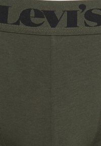 Olivgrüne Herrenunterwäsche mit gerippter Textur. Mit einem schwarzen Levi's-Logo auf dem elastischen Bund.