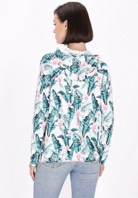 Lettert hættetrøje med et tropisk print af teal farvede blade og lyserøde blomster, lange ærmer og en afslappet pasform.