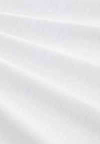 Witte stof met een gladde, gestructureerde oppervlakte, gekenmerkt door zachte rimpelingen en een subtiele glans, wat duidt op een lichtgewicht en zachte materiaaleigens.