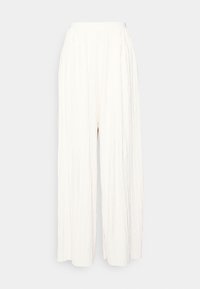 Vikta vida byxor i vitt tyg med elastisk midja. Har en flödande, strukturerad design utan synliga fickor eller metalldelar.