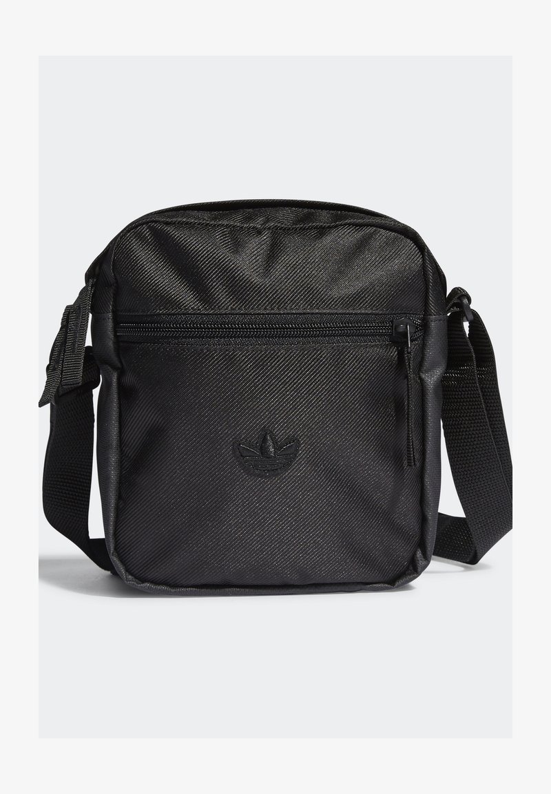 Černá látková taška přes rameno s texturovaným povrchem, přední kapsou na zip, nastavitelným popruhem a embosovaným logem na spodní části přední strany.