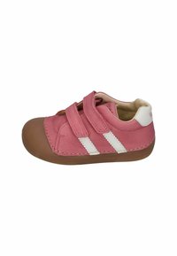 Pink leather shoe with brown rubber outsole, featuring two white stripes and Velcro straps for closure and comfort. Rounded toe design.