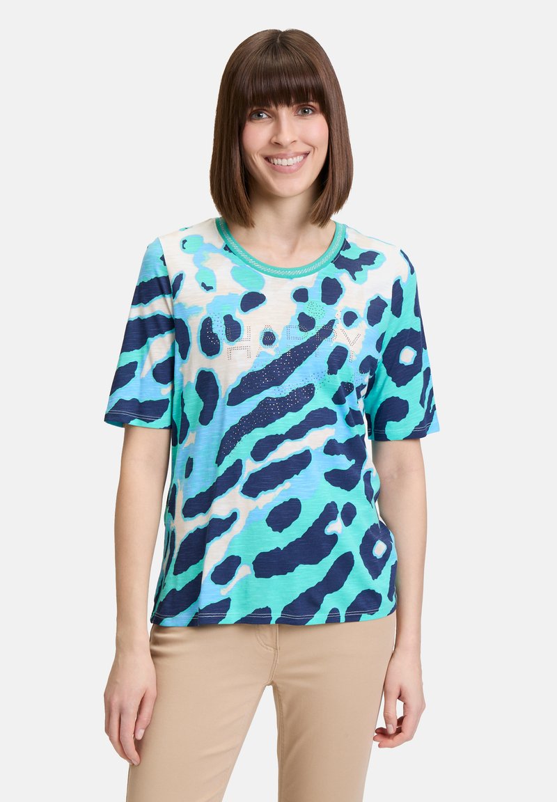 Short-sleeve T-shirt featuring a blue and turquoise leopard print design, round neckline, and a "HAPPY" text detail with rhinestones.