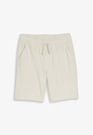 Jasnobeżowe, casualowe szorty z elastycznym pasem, sznurkiem do wiązania i bocznymi kieszeniami, ułożone płasko na białym tle.