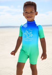 Muta a maniche corte con sfumatura blu e verde, decorata con un motivo di palma e la scritta "BEACH LIFE". Tessuto liscio ed elastico.