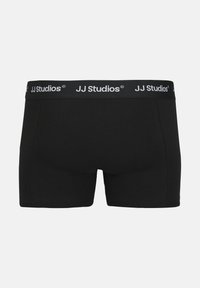 Schwarze Boxershorts aus Baumwollmischung. Mit einem elastischen Bund in Schwarz mit weißer Beschriftung. Glatte Textur, körperbetontes Design.