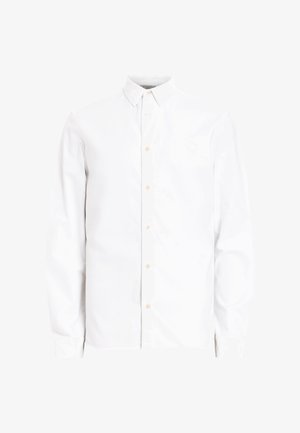 Hvid langærmet skjorte med knaplukning og krave, som har lysebrune knapper og en glat bomuldsstruktur. Enkel, klassisk design.