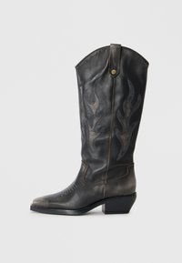 Black leather cowboy boot with flame-like stitching, pointed toe, and a low block heel. Features a decorative metallic button on the side.