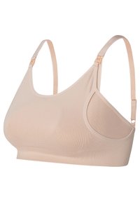 Letvægt beige trådløs bh lavet af glat stof, med justerbare stropper og et sømløst design uden synlig hardware.
