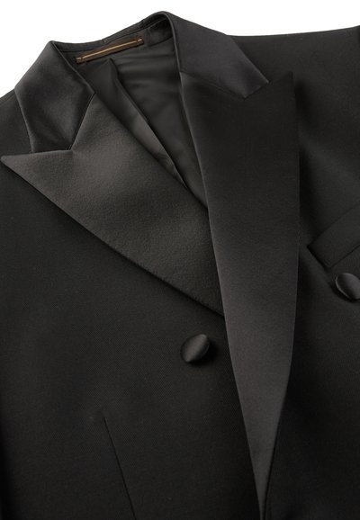 Zwarte tuxedo jasje met satijnen piek-revers, dubbelzijdig ontwerp, twee knopen en een getextureerde stof. Binnenvoering is glad.