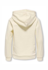 Sweat à capuche de couleur crème avec capuche, manches longues et poignets côtelés. Tissu doux avec une texture lisse, sans logos ni motifs visibles.