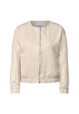 Veste beige clair avec un col rond, une fermeture éclair sur toute la longueur à l'avant, des poignets élastiques et deux poches avant à patch. Finition en tissu lisse et mat.
